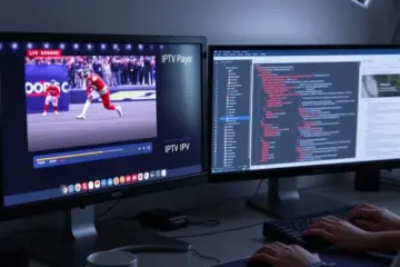 alt_text: A developer's split-screen desk: live sports on an IPTV player on the left monitor, coding on the right monitor with hands on the keyboard.