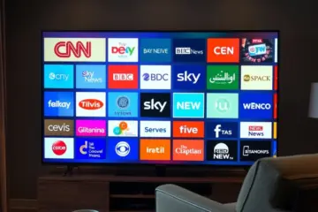 alt_text: A stylish living room with a TV displaying a grid of global news channel logos, conveying an informed, connected worldview.